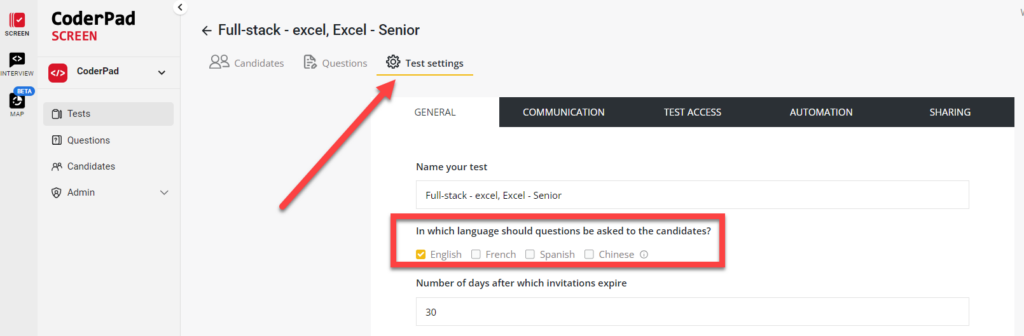 An arrow pointing toward "Test settings" tab at the top. On the screen the "In which language should questions be asked to the candidate?" with the "english" option checked.