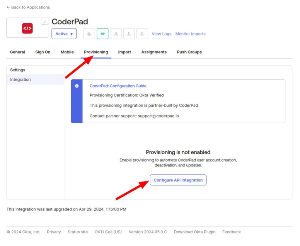 The image shows a screenshot of the CoderPad integration settings page in Okta, specifically under the "Provisioning" tab, which is highlighted with a red arrow pointing to it. The main section indicates that provisioning is not enabled and provides a button labeled "Configure API Integration," which is pointed to by another red arrow. The section also includes a blue information box titled "CoderPad: Configuration Guide" stating that the provisioning certification is Okta Verified and that the integration is partner-built by CoderPad, with contact support information provided. At the bottom, it notes that the integration was last upgraded on April 29, 2024, at 1:16:00 PM. The footer includes links for Privacy, Status site, OK11 Cell (US), Version 2024.05.0 C, Download Okta Plugin, and Feedback.